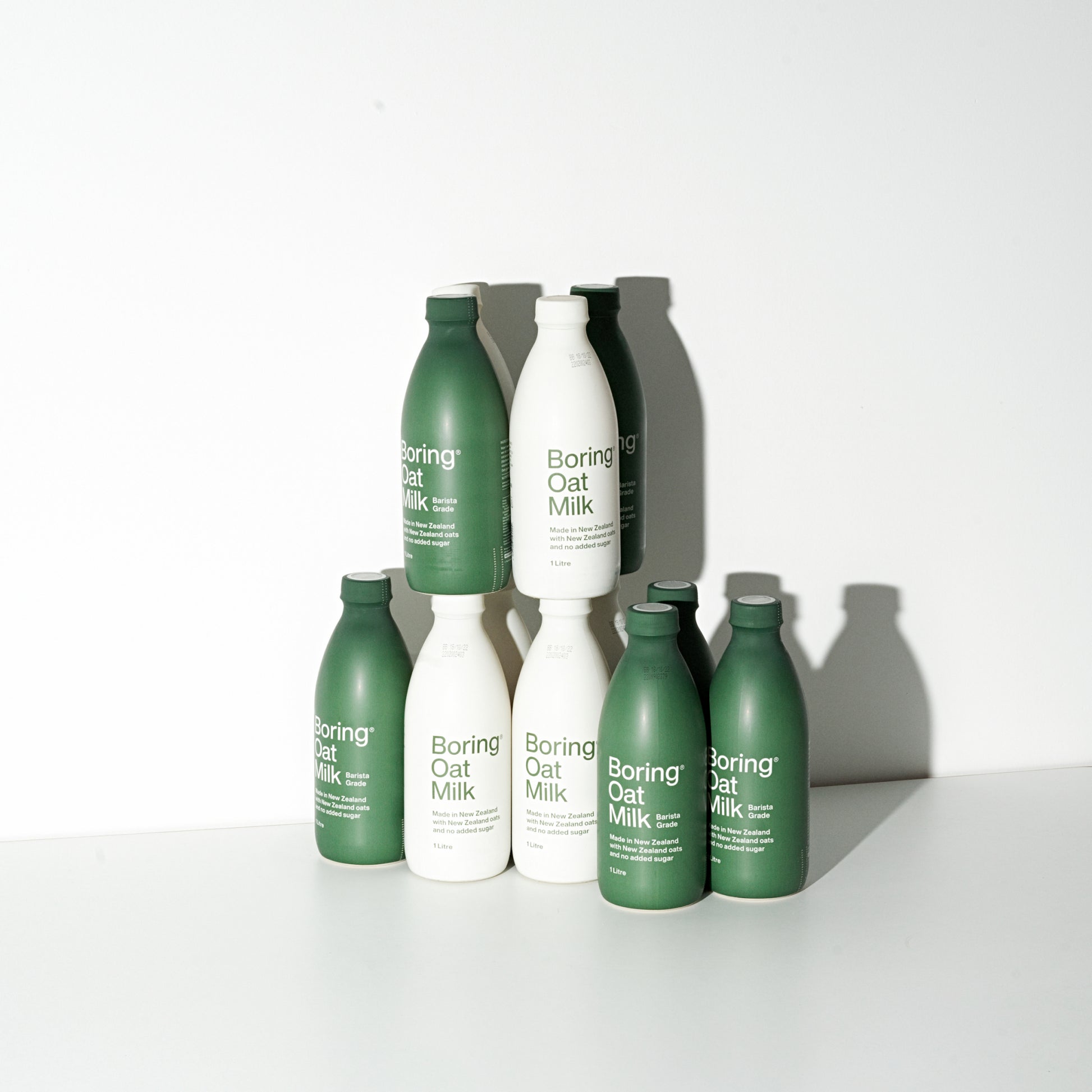 Collection of boring oat milk products stacked upon one another